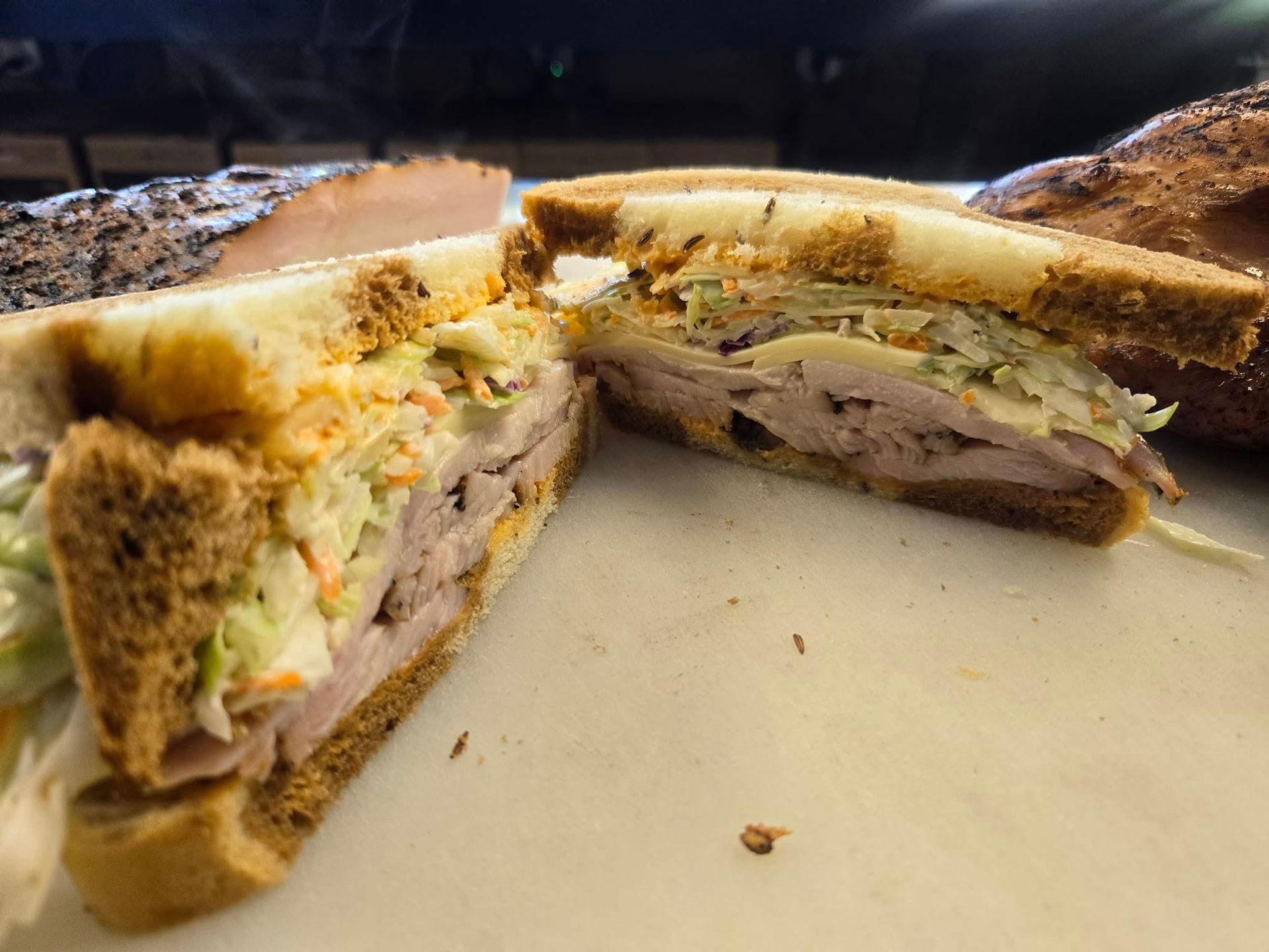 A sandwich is cut in half on a white plate.