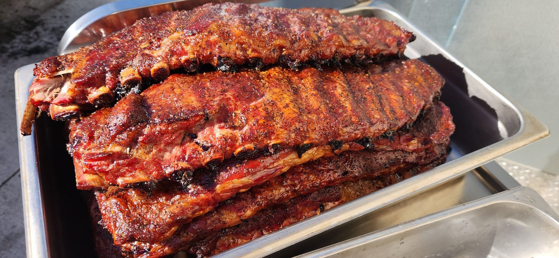 A tray of ribs is sitting on a table.