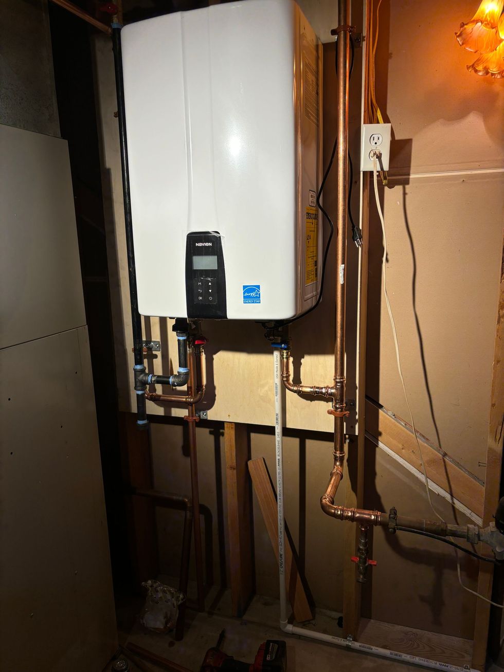 Air conditioning units with toolbox and gloves in backyard.
