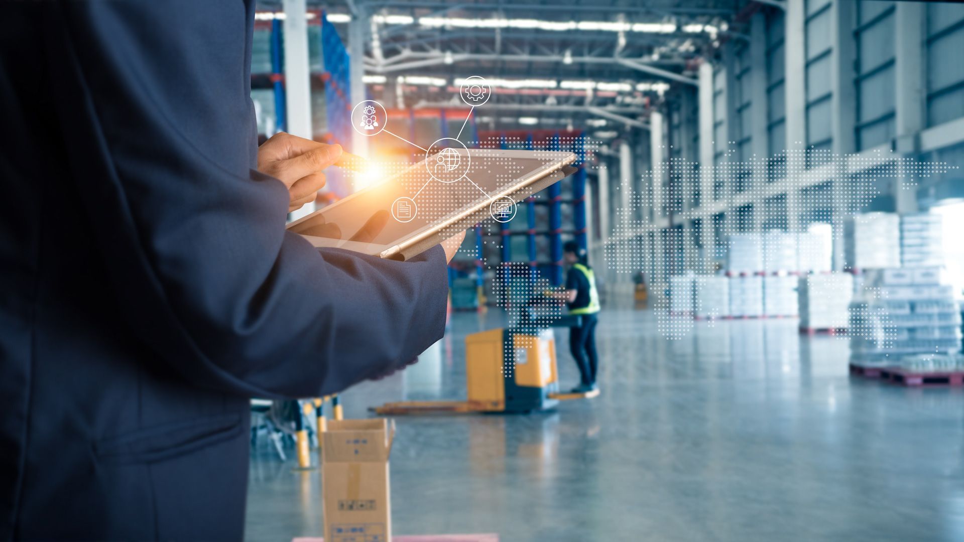 Person in suit using tablet, overlaid with data network, in warehouse setting.