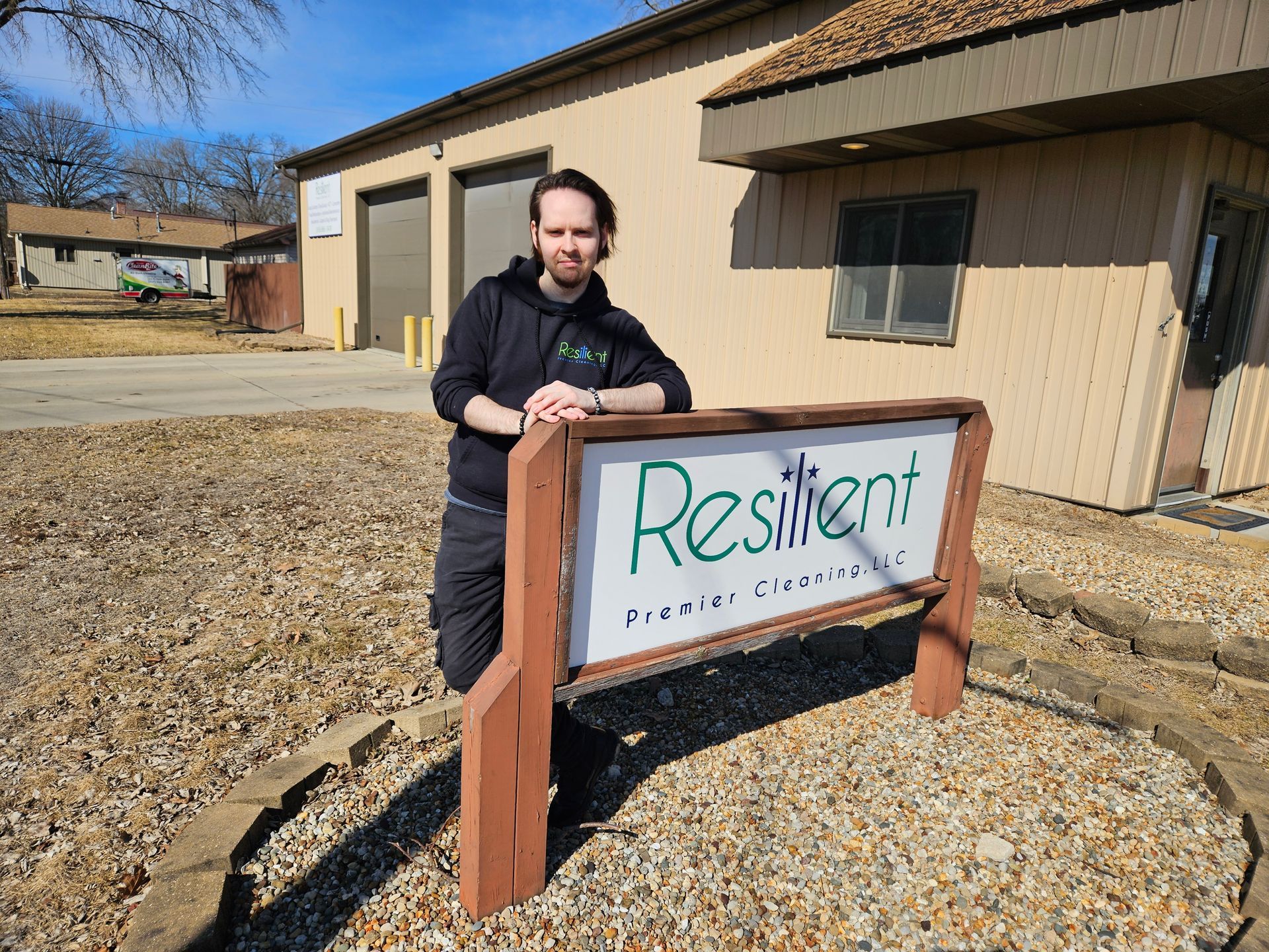 Person leans on a sign that reads