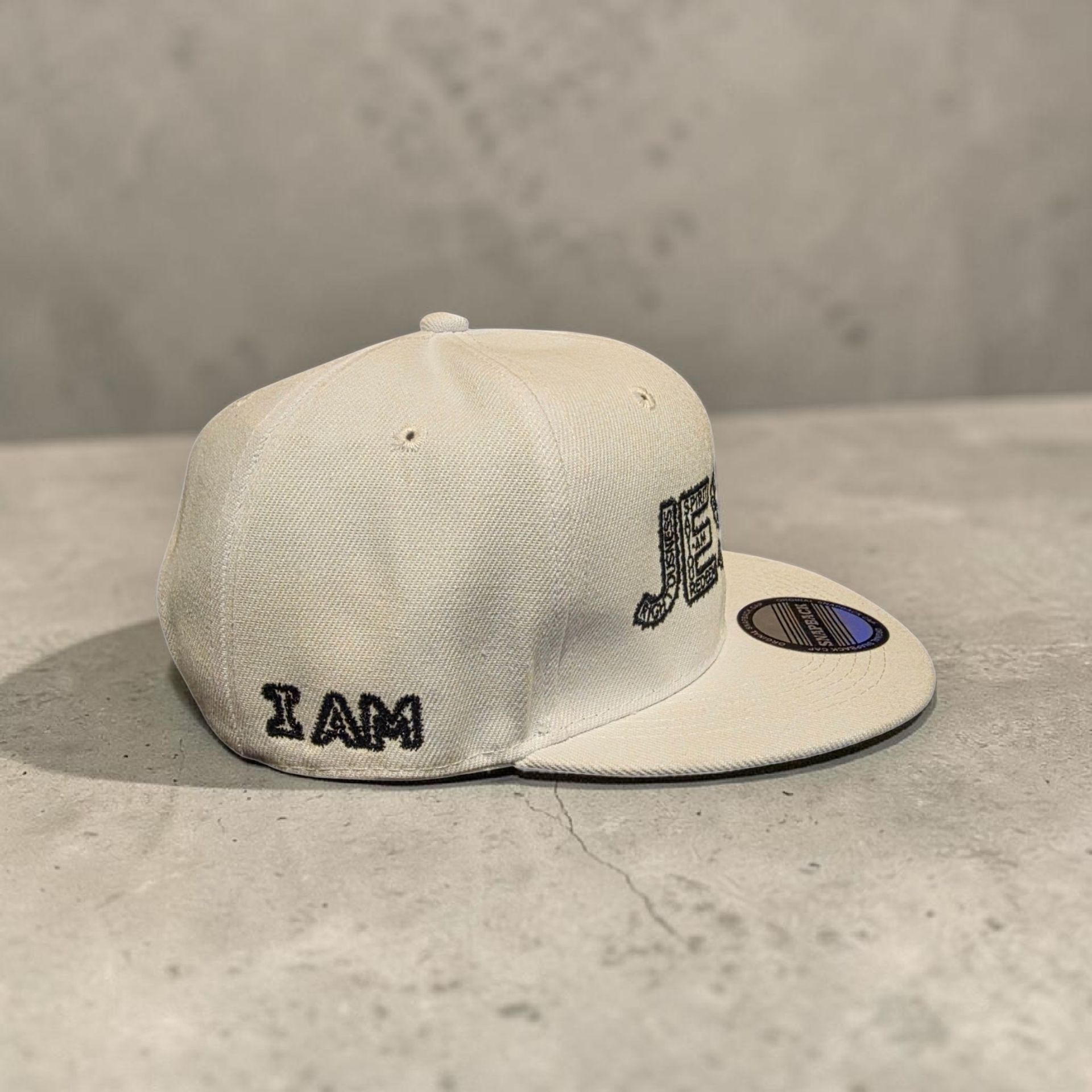 White hat with black letters- Snap back- one size fits most