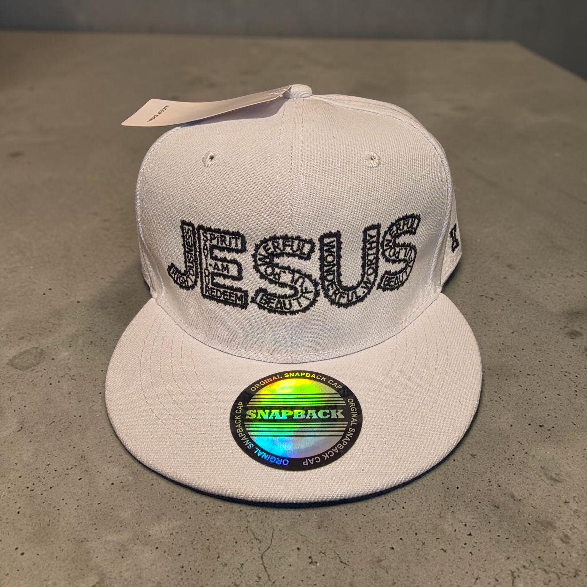 White hat with black letters- Snap back- one size fits most