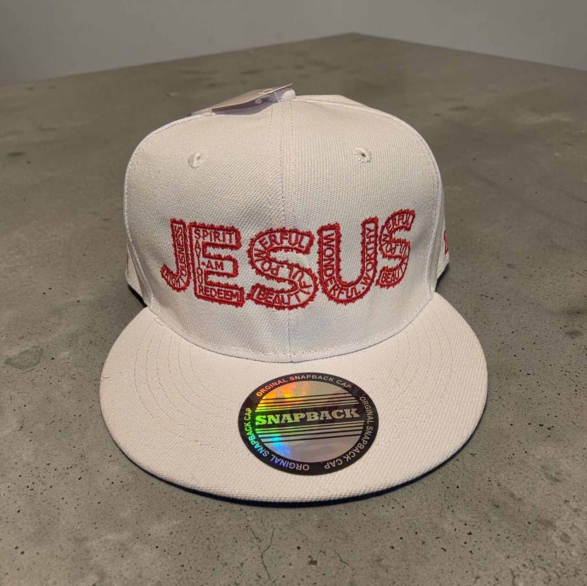 White hat with red letters- Snap back- one size fits most