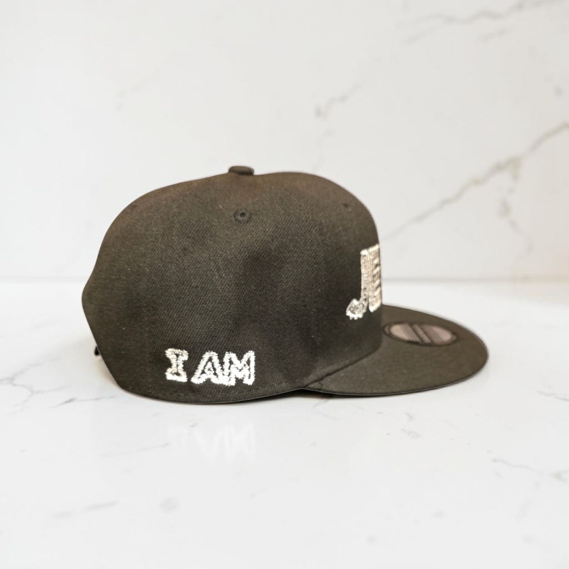 Black hat with white letters- Snap back- one size fits most