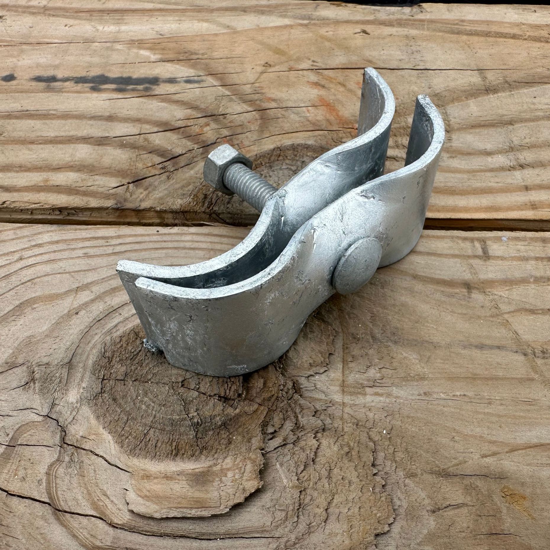 A metal object is sitting on a piece of wood