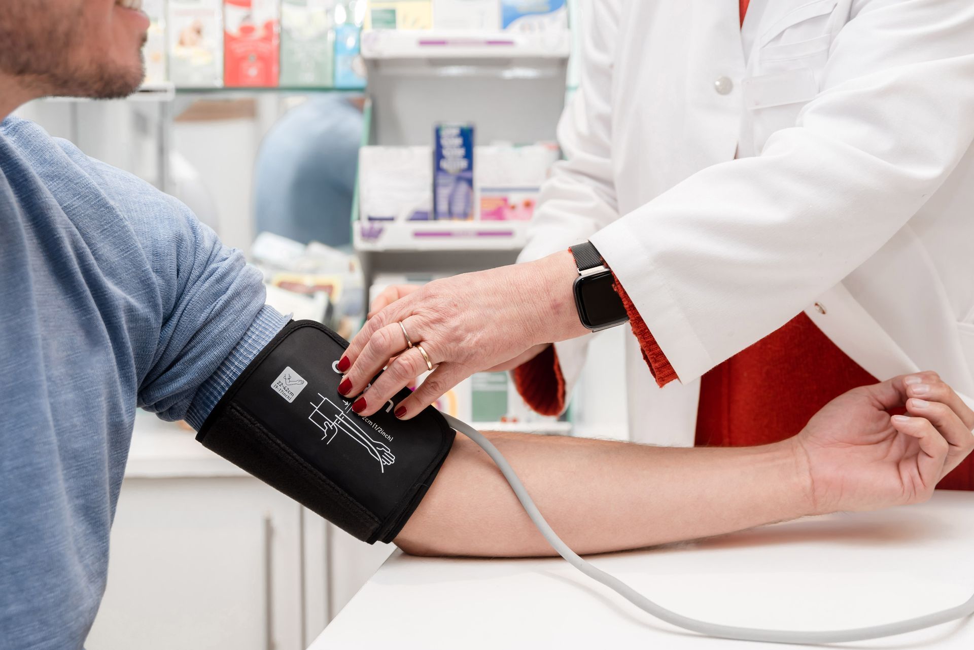 Der Arzt misst in der Klinik den Blutdruck des Patienten mit einer Blutdruckmanschette.