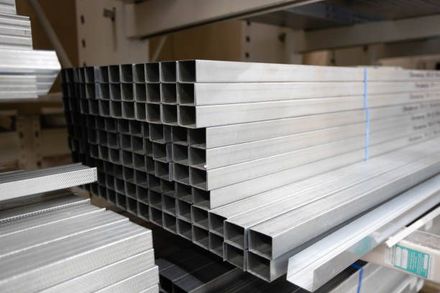 A bunch of metal tubes are stacked on top of each other