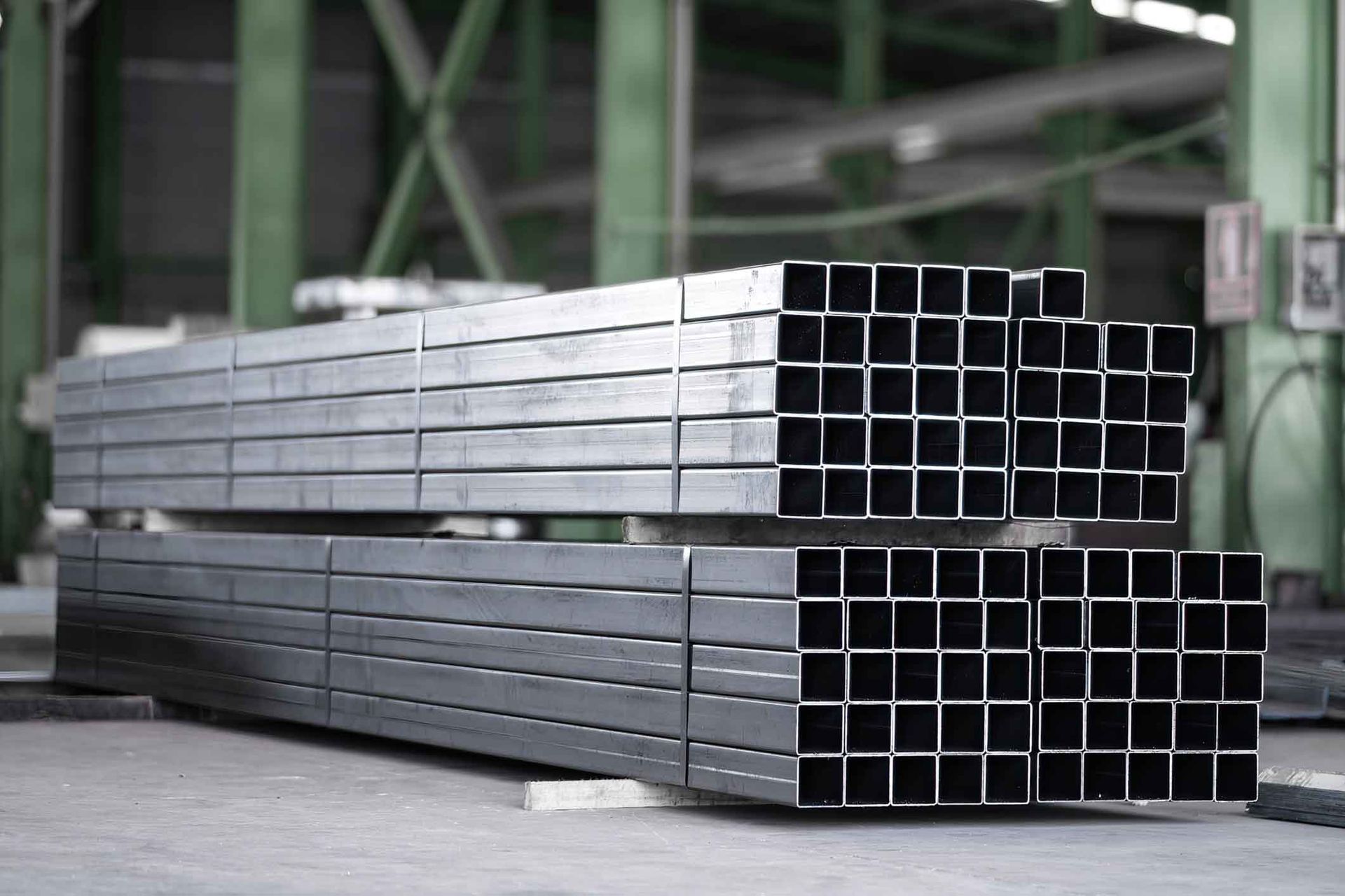 A stack of metal pipes sitting on top of each other in a factory.