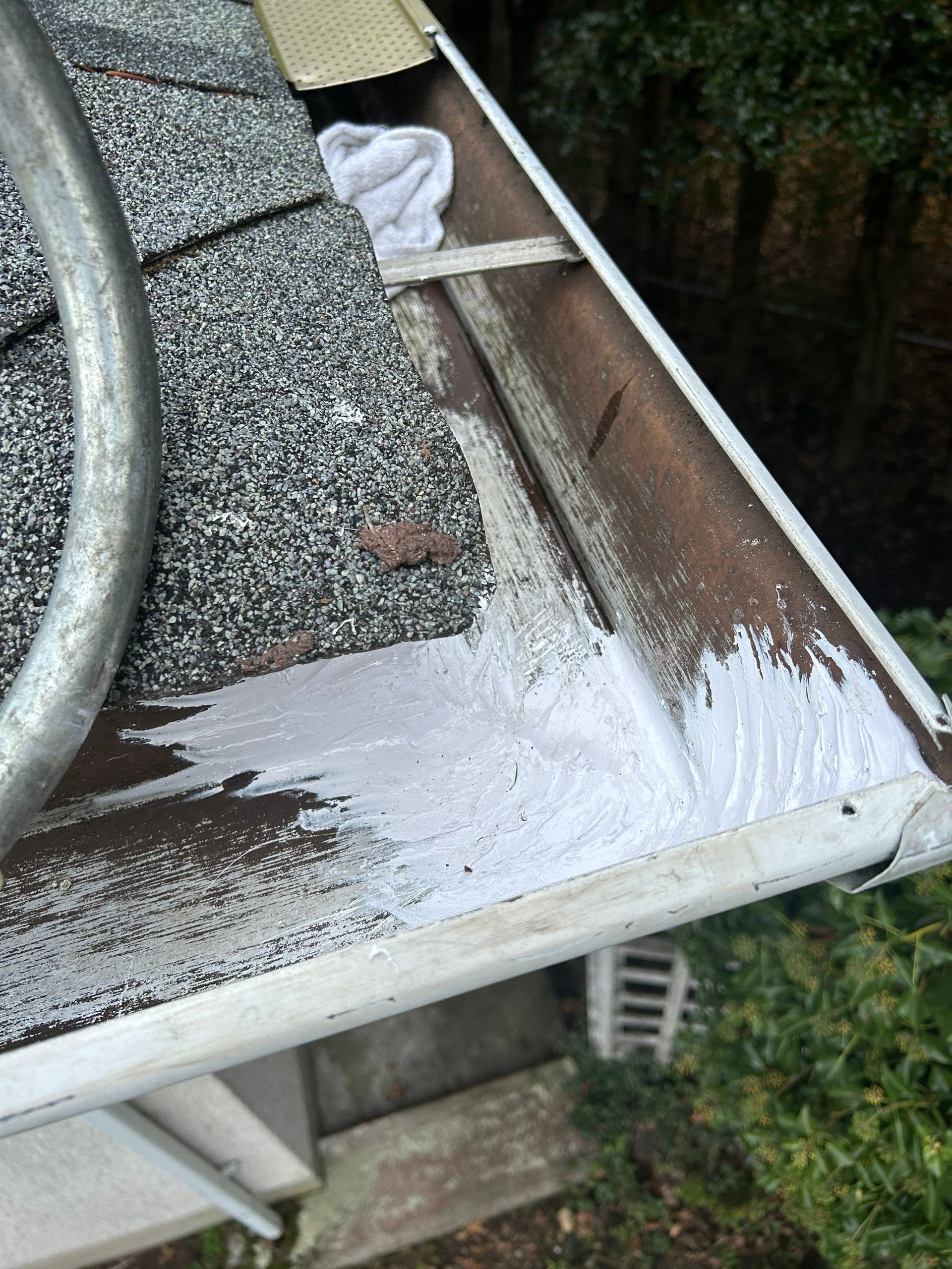 The corner of an existing gutter with sealant that we replaced due to the old caulking failing causing a leak