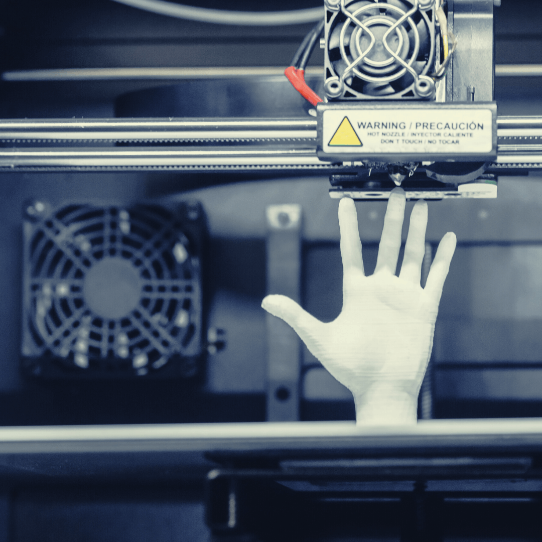 A hand is reaching out from a 3d printer with a warning sign on it