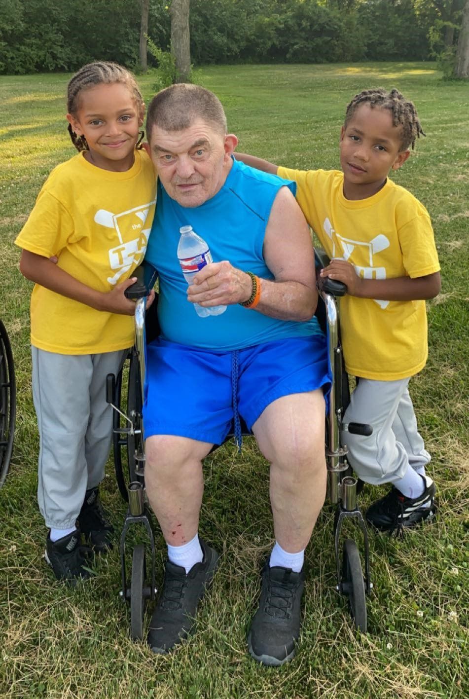 resident in a wheelchair with two visitors