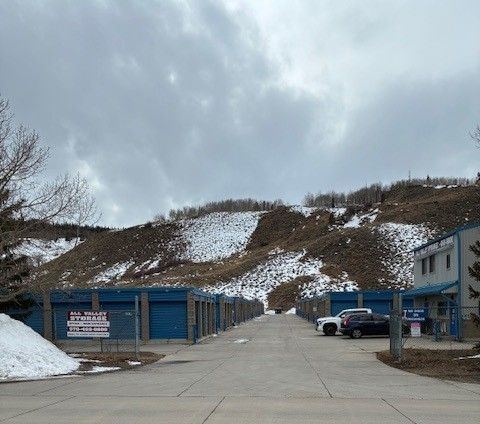 Storage Units With Snowy Hill Backdrop