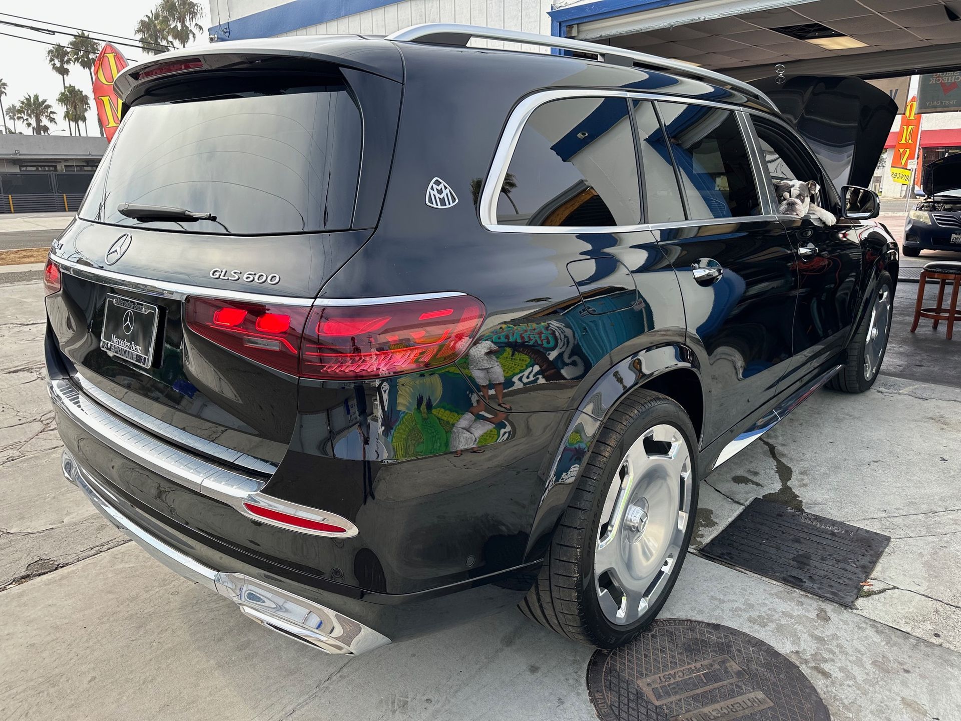 Black SUV parked on a street, rear three-quarter view with chrome trim and tinted windows