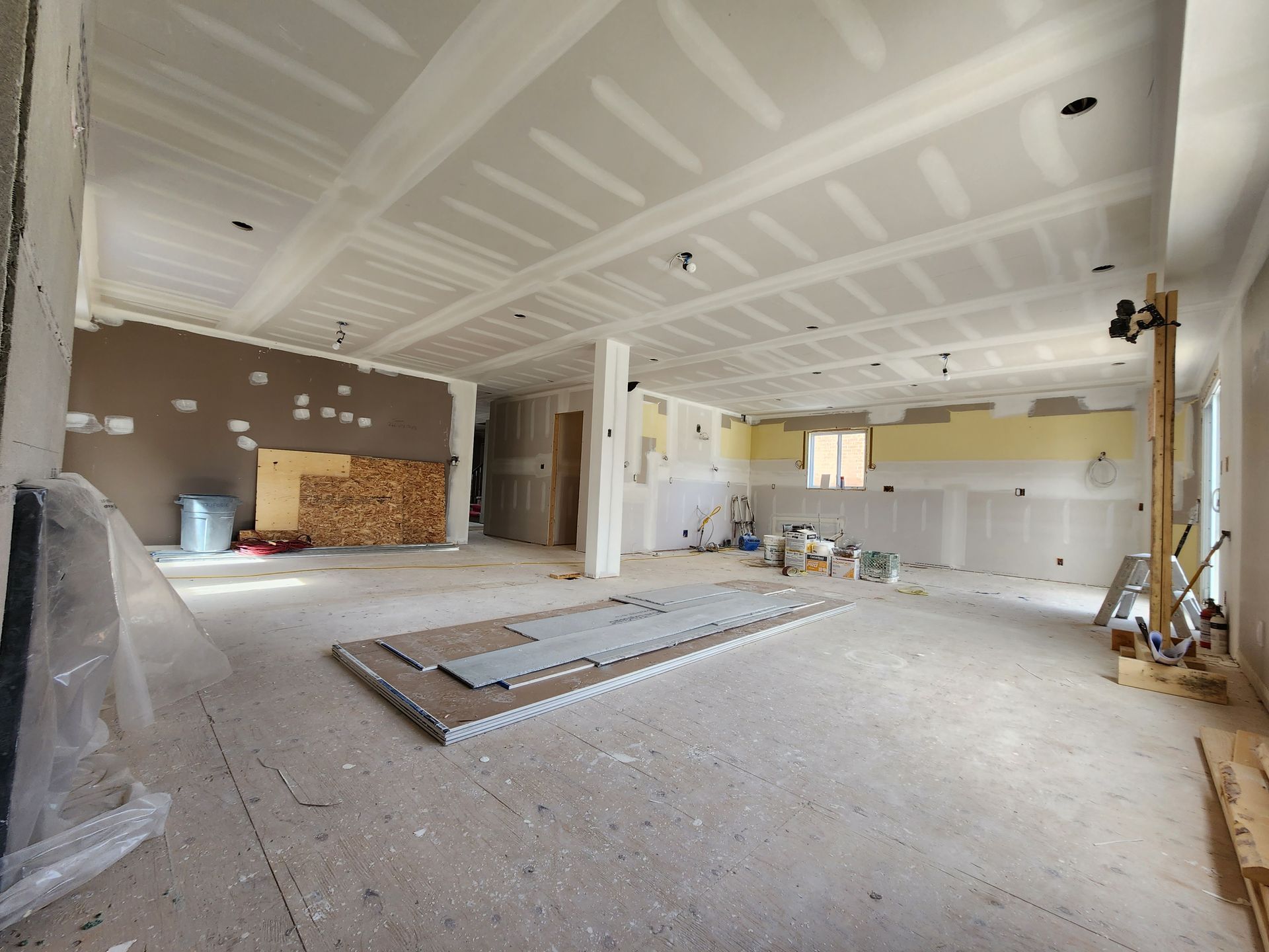 a large room that is being remodeled with drywall on the ceiling