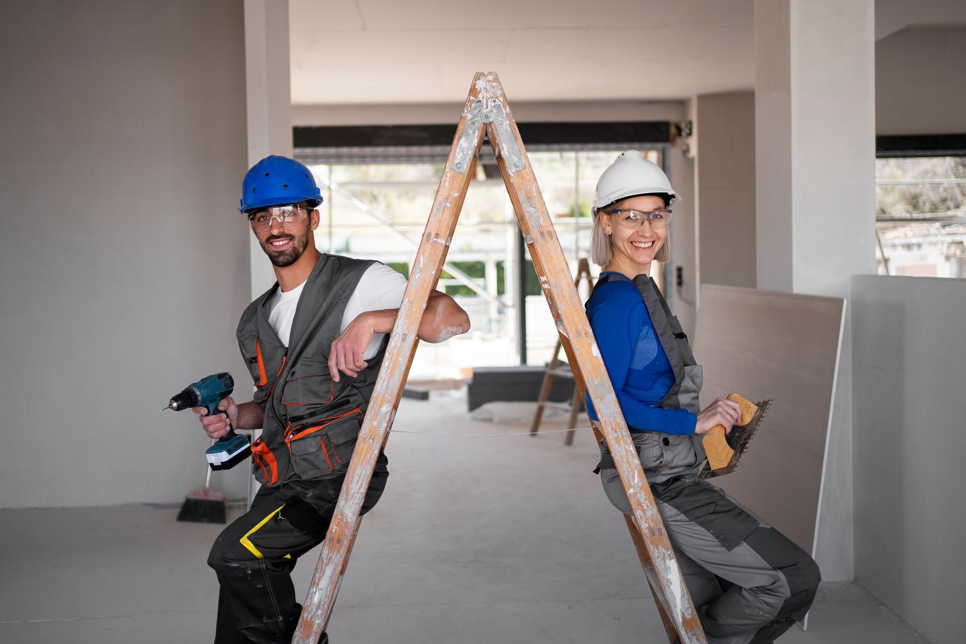 a man and a woman are sitting on a ladder .