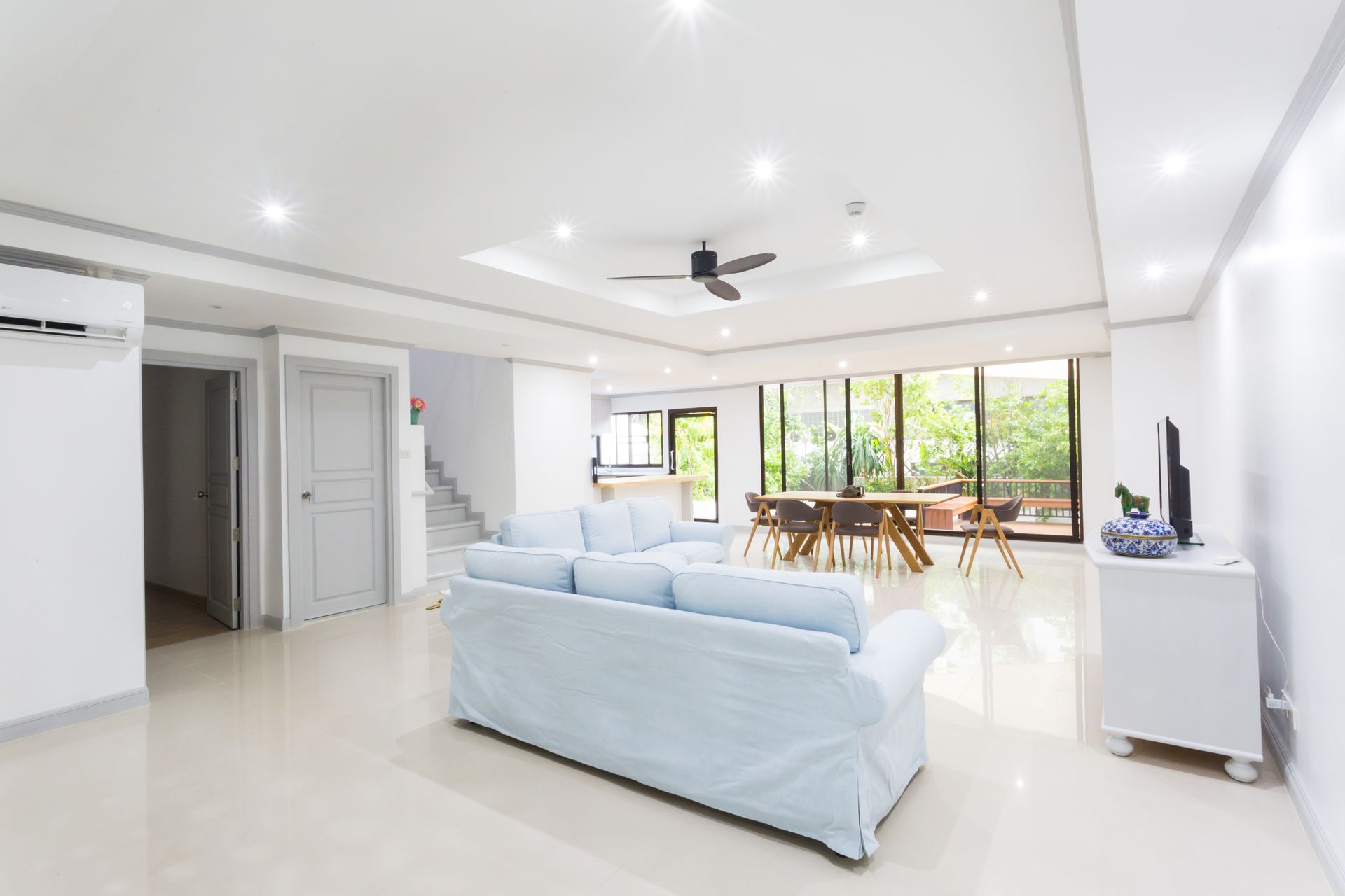 a living room with a couch , chairs and tables .