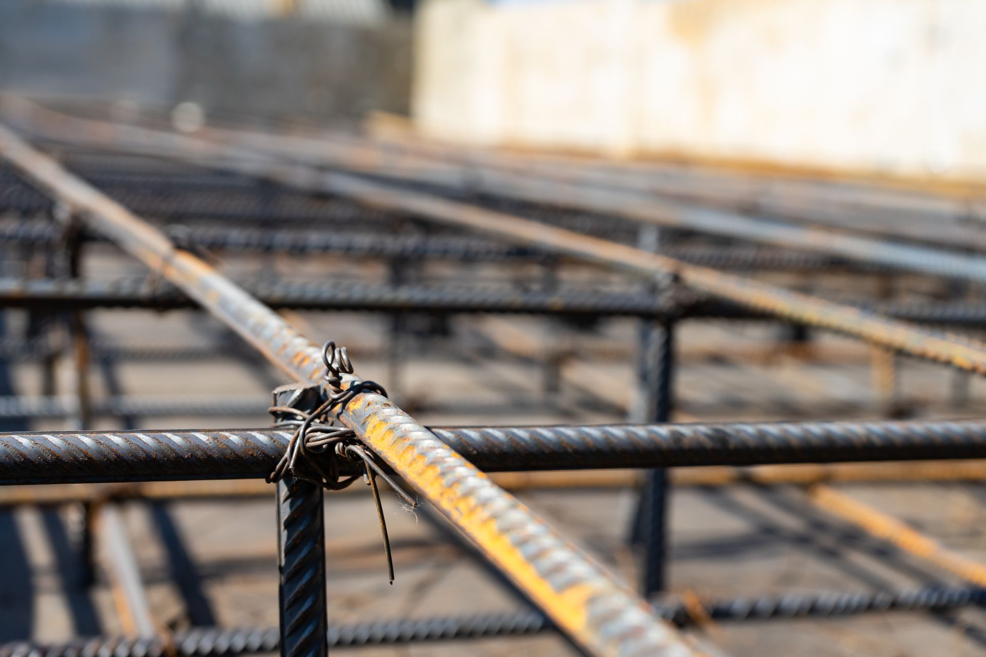a close up of a bunch of metal bars on a construction site .