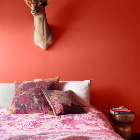 Bedroom With Red Wall, Bed With Floral Bedding and Pillows — GV painting in Shepparton, VIC
