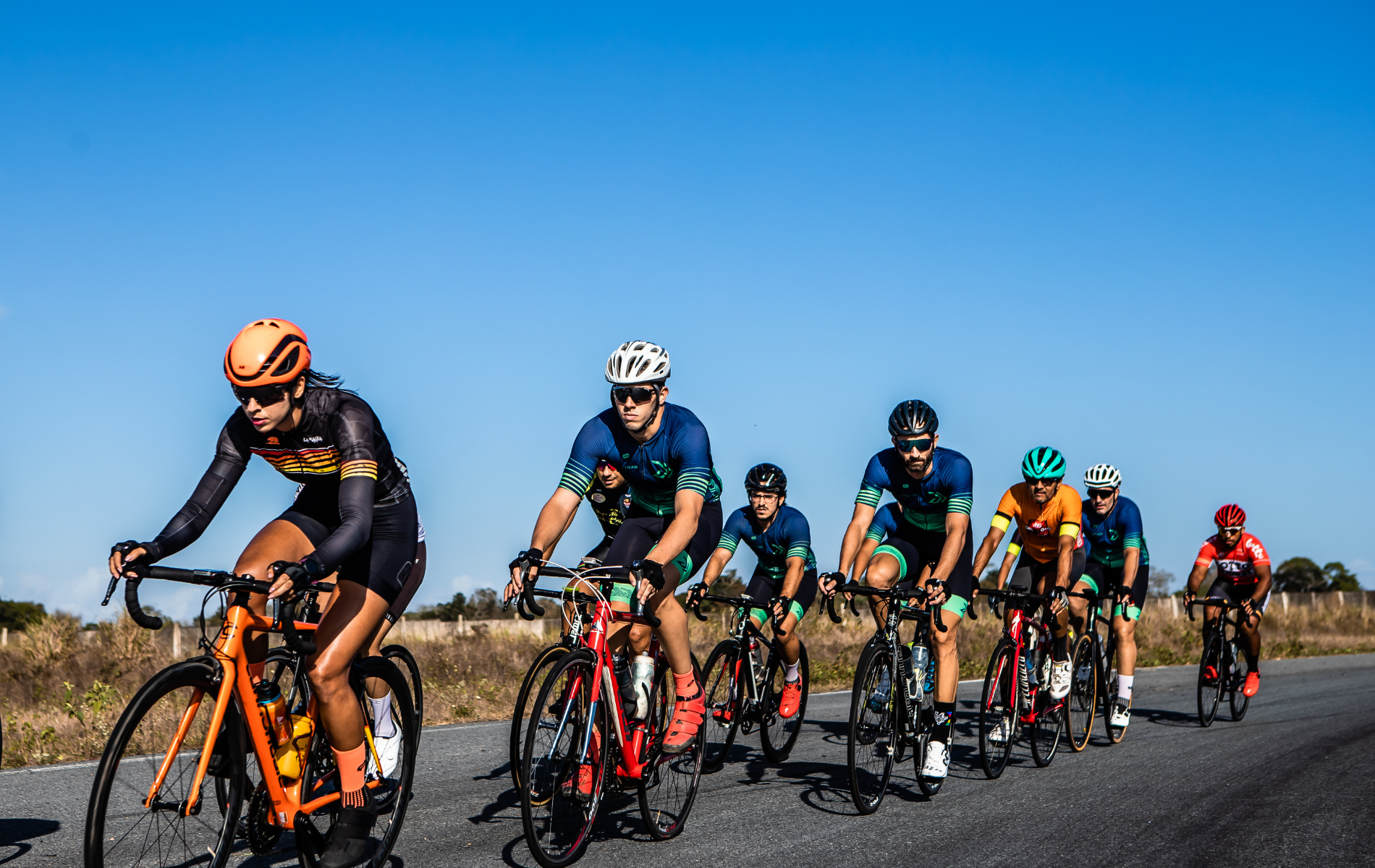 A group of people are riding bicycles down a road.