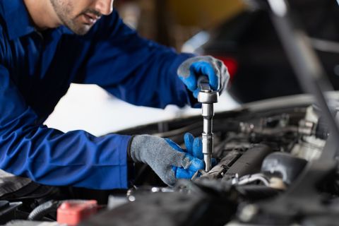 A Man Wearing Blue Gloves is Working on a Car — Smyrna, GA — All Pro Transmission Exchange LLC A Man Wearing Blue Gloves is Working on a Car — Smyrna, GA — All Pro Transmission Exchange LLC