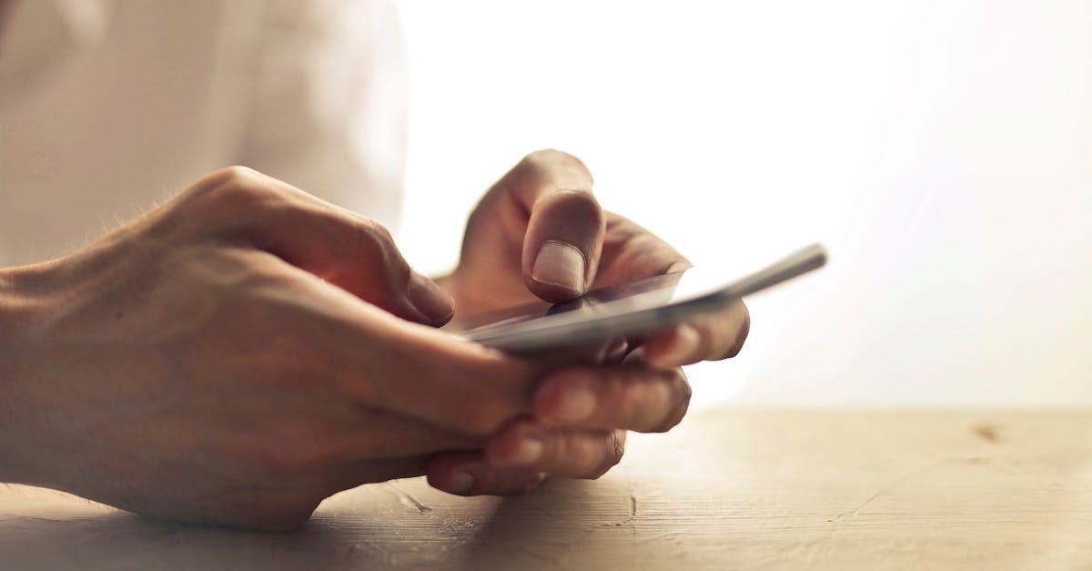 Someon's hands holding a smartphone.