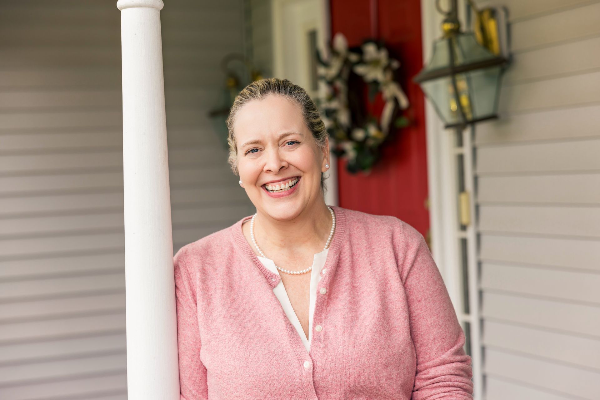 Joy Strickland, therapist specializing in people pleasing, smiling outside her office.