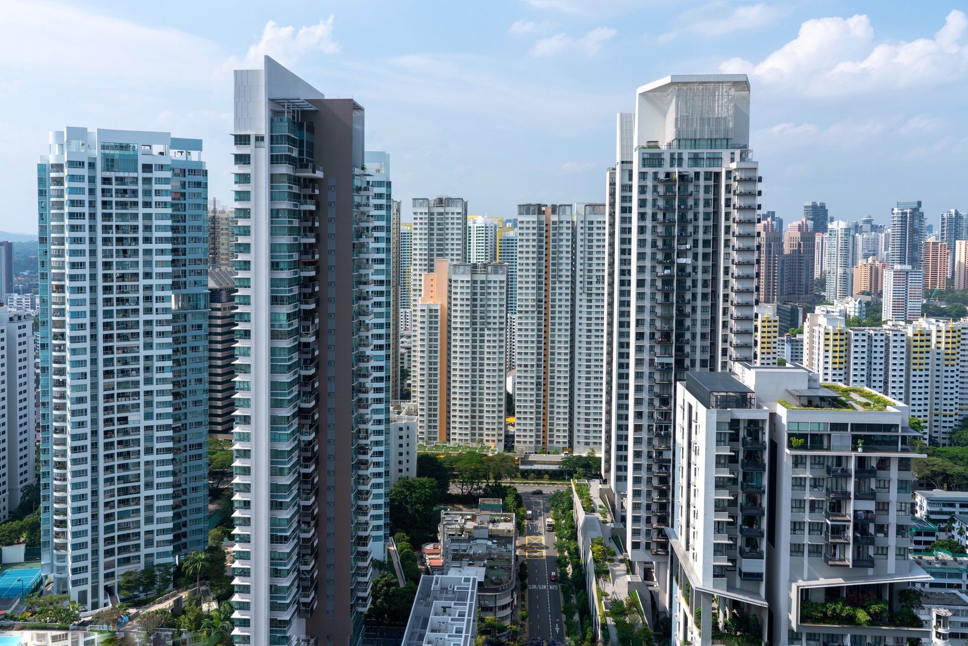 Skyline of modern high-rise apartment towers under a bright blue sky