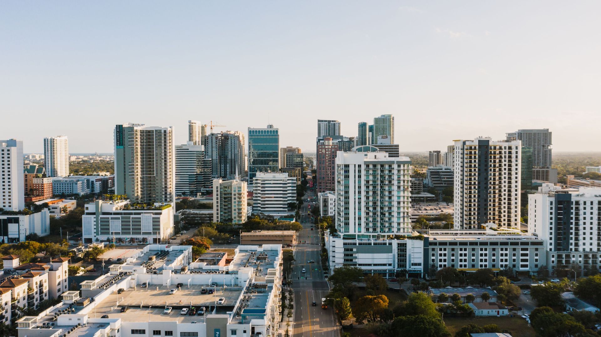 City skyline with modern high-rise apartment buildings under a clear sky.