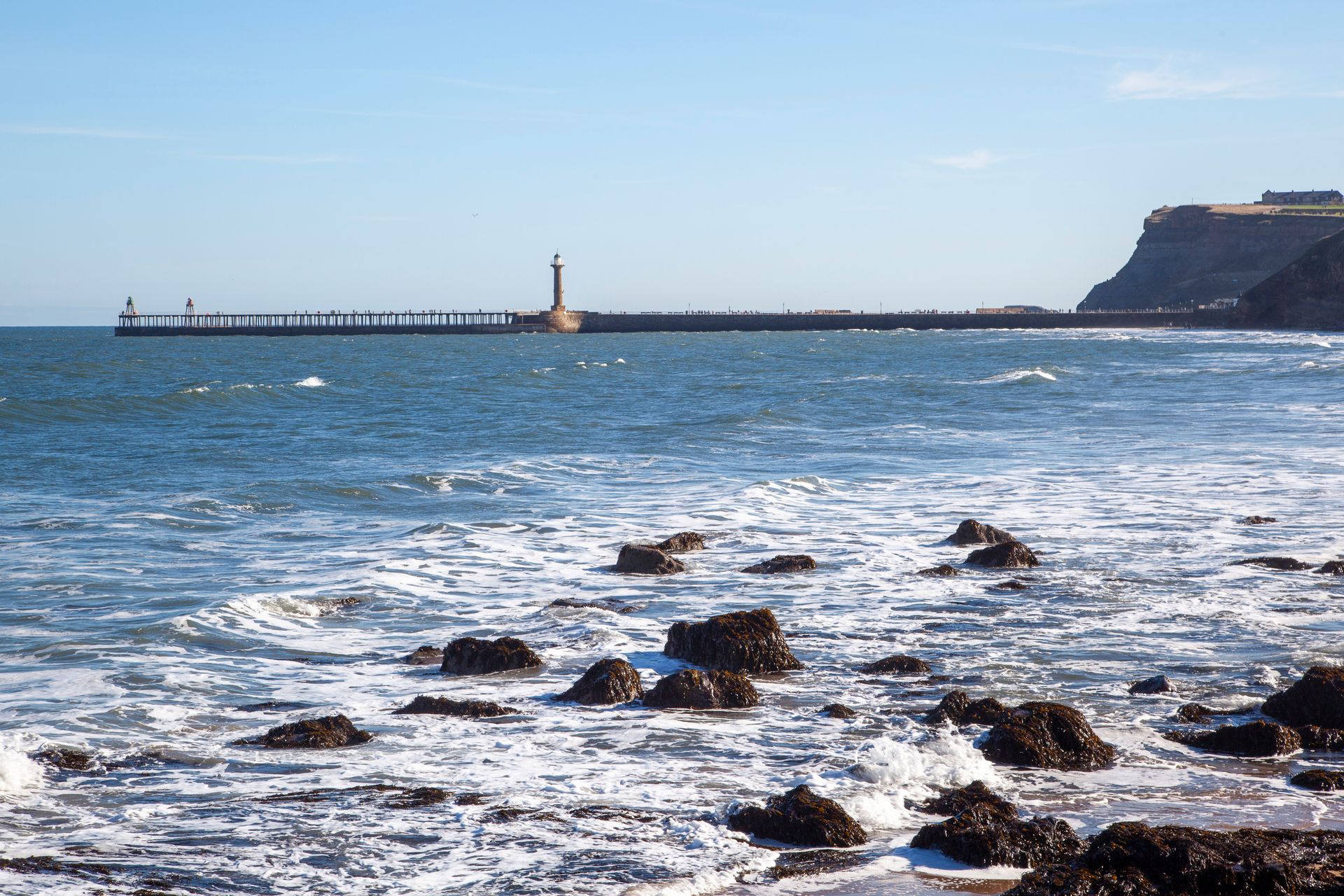 A large body of water with a pier in the background