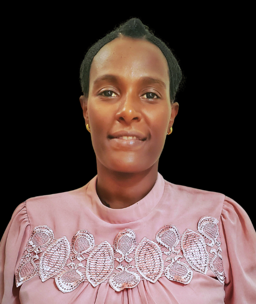 A woman is wearing a pink shirt with white embroidery on the front.