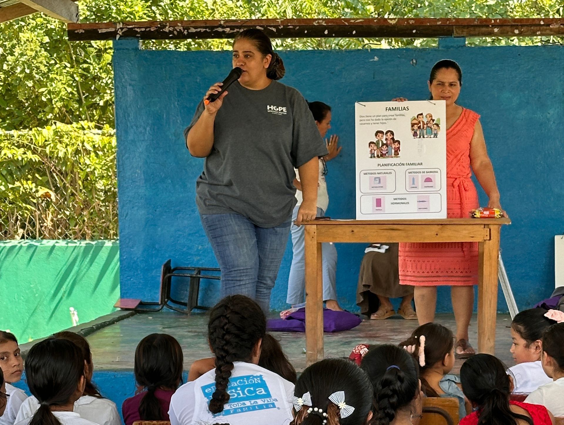 A woman is giving a presentation to a group of children
