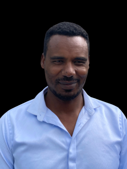 A man with a beard is wearing a light blue shirt