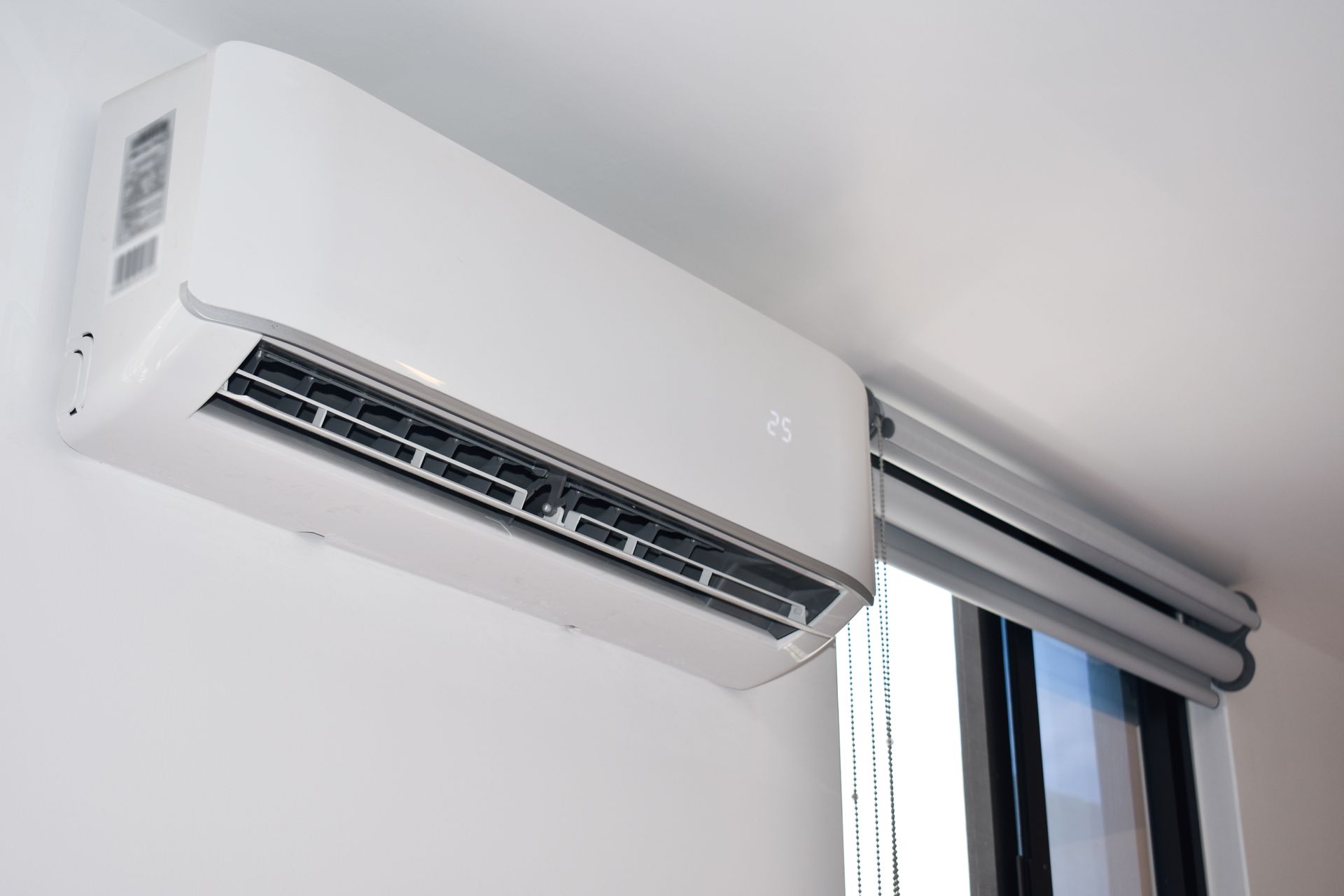 Indoor ductless HVAC unit installed above a window for reliable climate control.