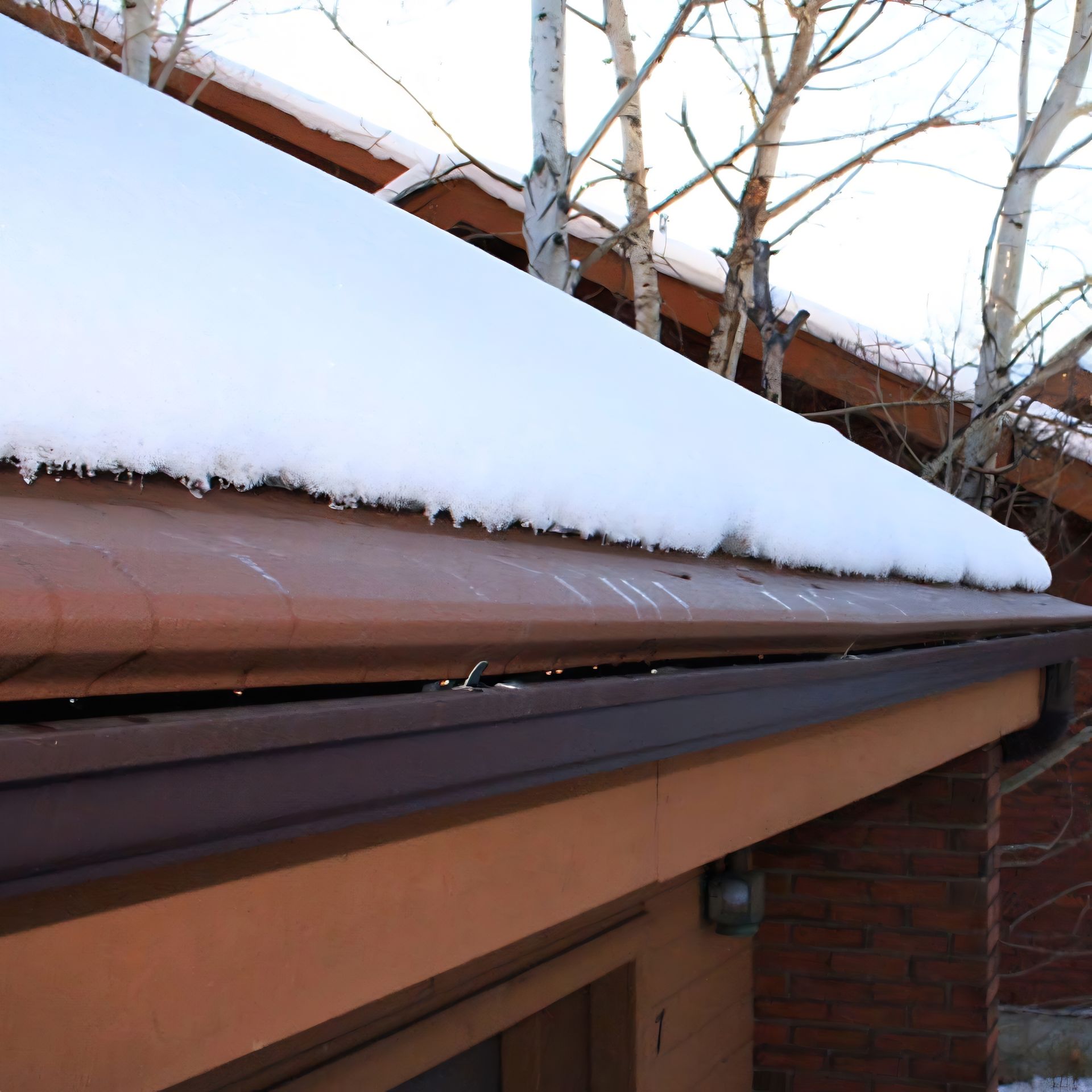 Snow melting due to heated Gutter Helmet