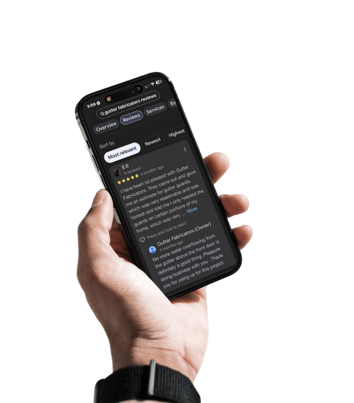 Hand holding a black smartphone displaying a review, with a dark screen and light text.