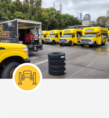 Yellow delivery trucks lined up | Hangar Unlimited Auto Care & Tires