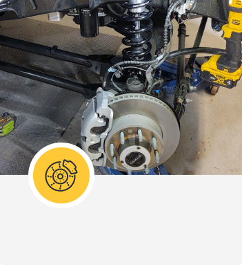Car front suspension with brake rotor | Hangar Unlimited Auto Care & Tires