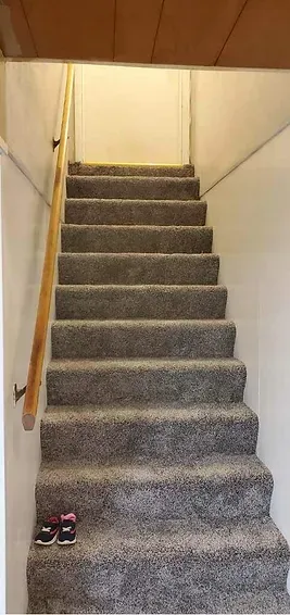 A set of stairs leading up to the second floor of a house.