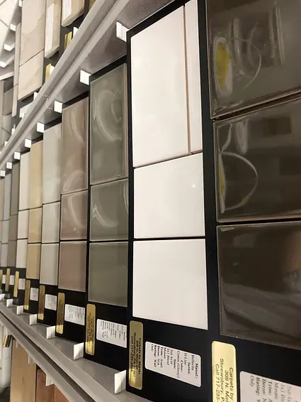A row of tiles are lined up on a shelf in a store