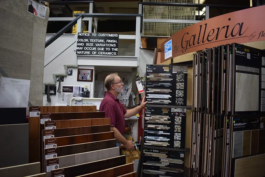 A man is standing in front of a sign that says galleria