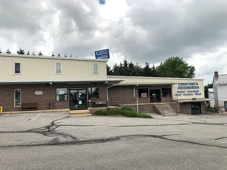 A large building with a parking lot in front of it.
