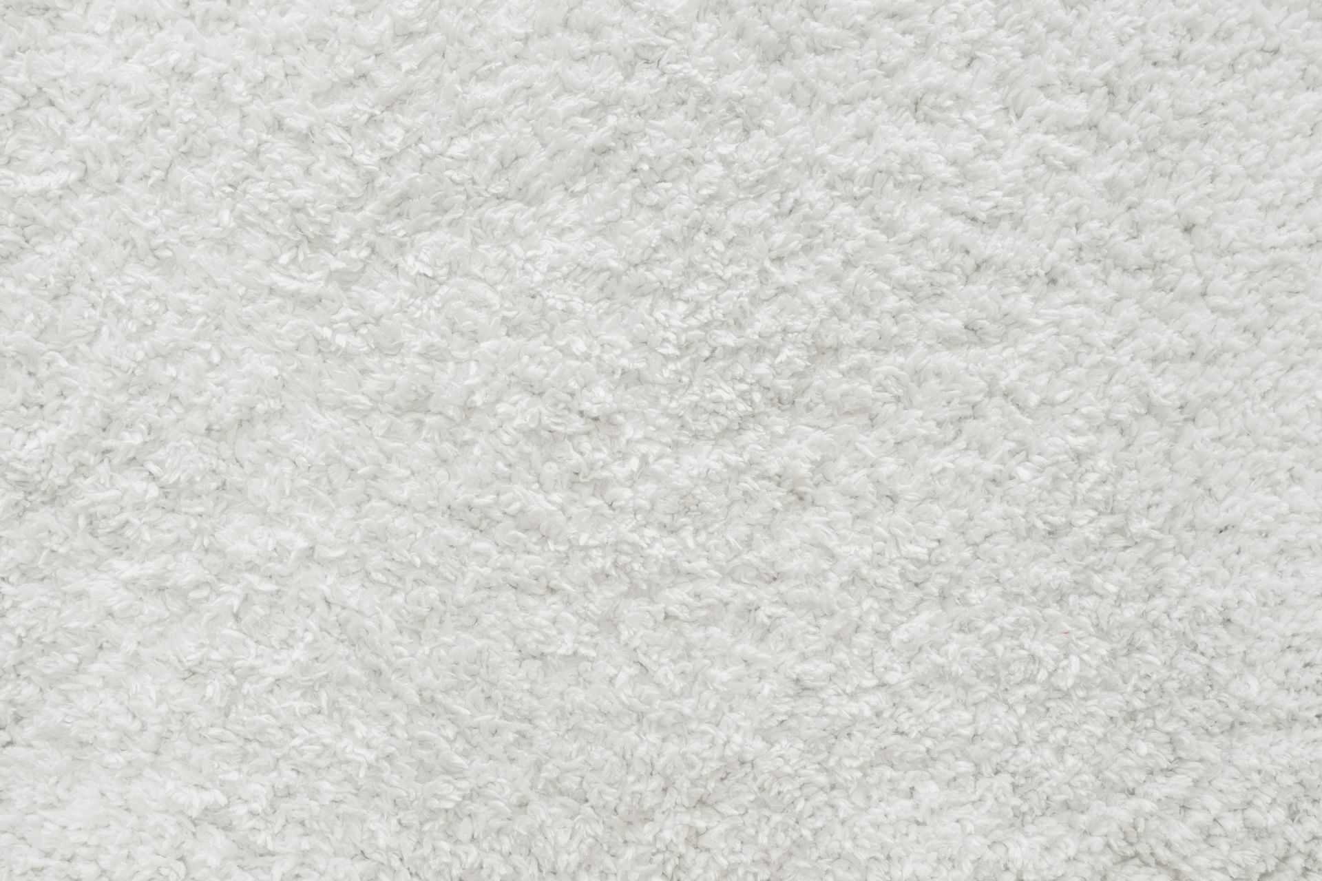 A close up of a white carpet texture.
