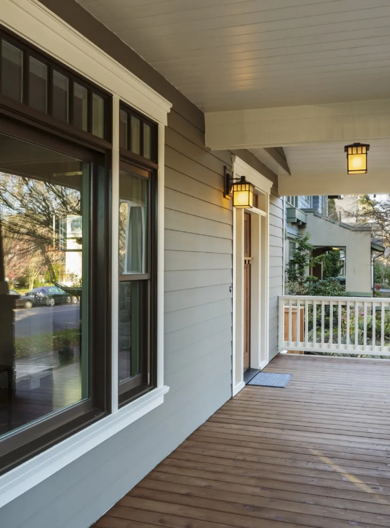 A porch of a house with a white railing