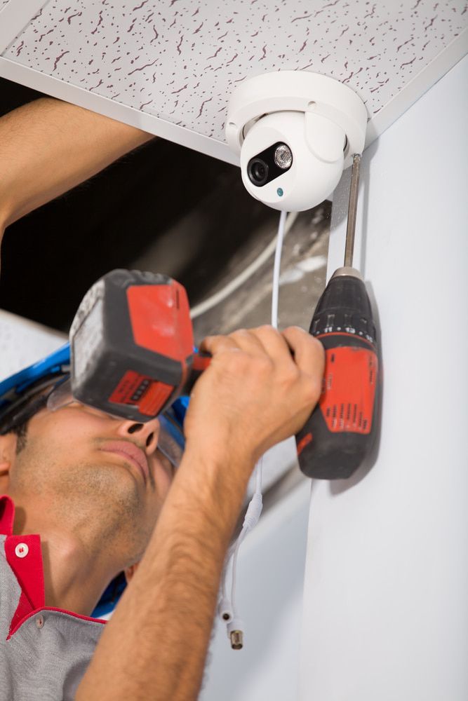A Man is Installing a Security Camera on the Ceiling — Hendo's TV Antennas & Installations in White Rock, QLD