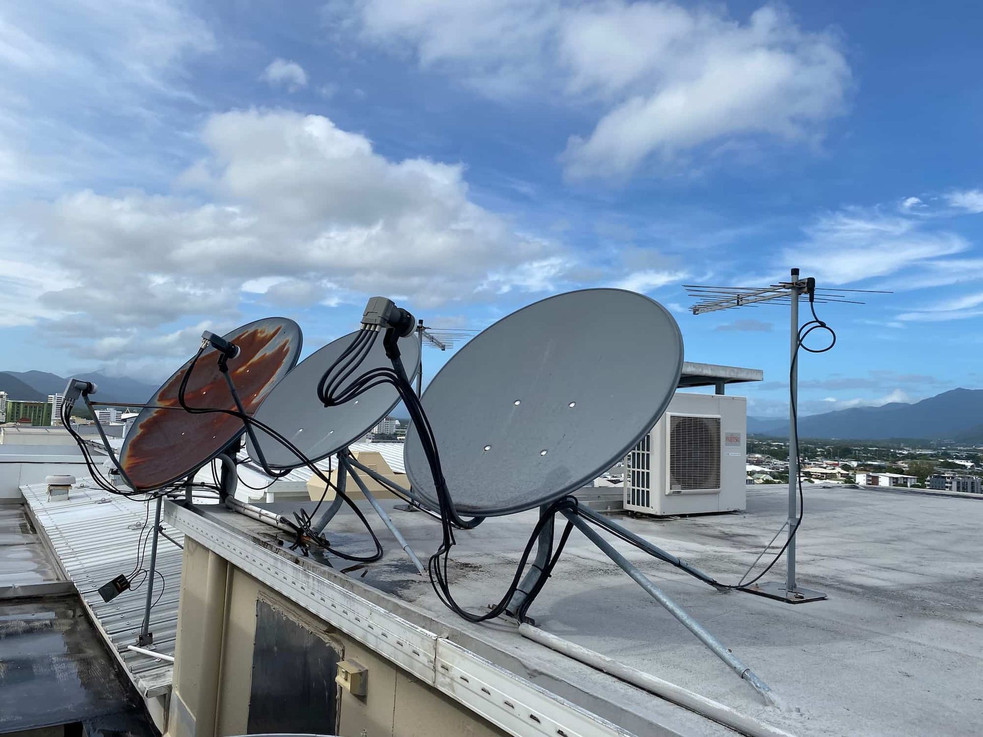 A Row of Satellite Dishes Are Sitting on Top of a Roof — Hendo's TV Antennas & Installations in White Rock, QLD