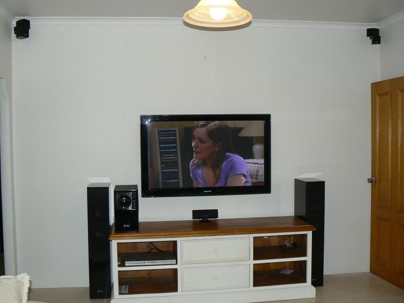 A Flat Screen Tv Shows a Woman in a Purple Shirt — Hendo's TV Antennas & Installations in Mission Beach, QLD