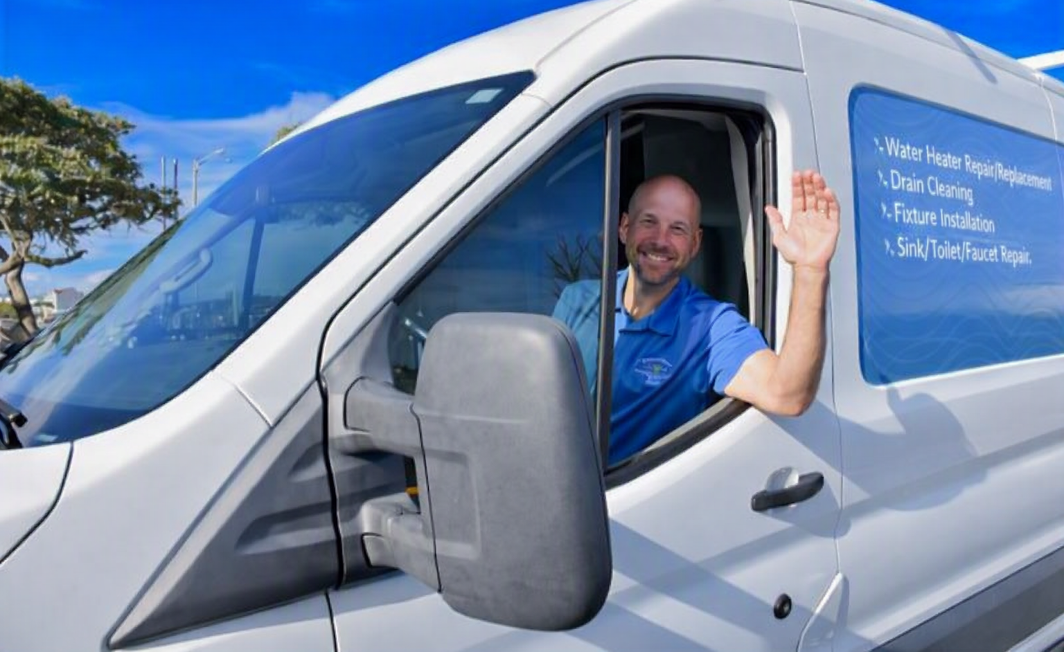 Driver waving from white work van under blue sky