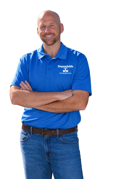 Smiling man in a blue polo shirt and jeans standing with arms crossed on a white background