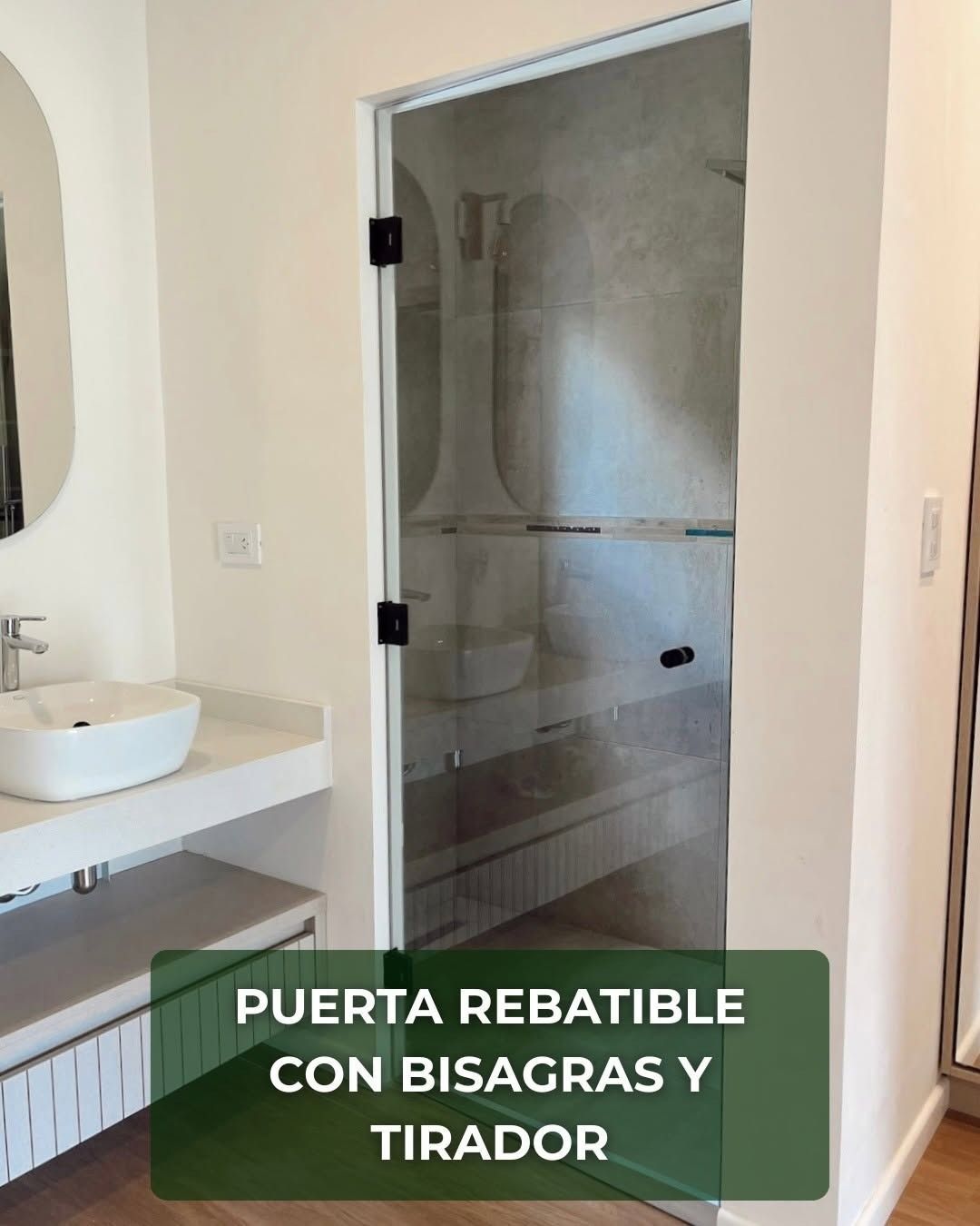 Puerta de baño abatible de vidrio esmerilado con bisagras y tirador, junto a lavabo blanco.
